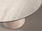 Round dining table in porcelain stoneware and wood clad with a flexible porcelain stoneware laminate