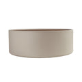 Round coffee table in walnut and sand-colored faux leather-covered wood