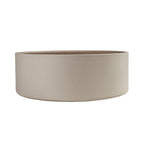Round coffee table in walnut and sand-colored faux leather-covered wood