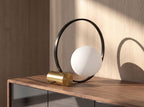 White glass and black steel table lamp with polished golden steel base